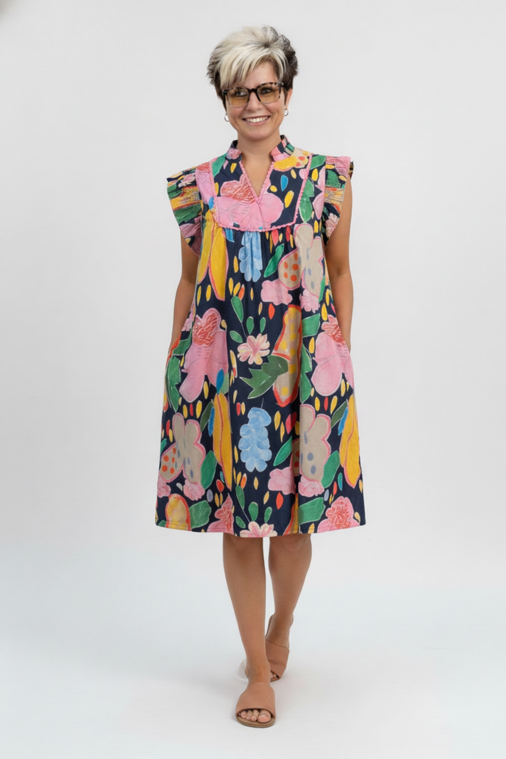 Woman wearing a colorful floral dress on a white background