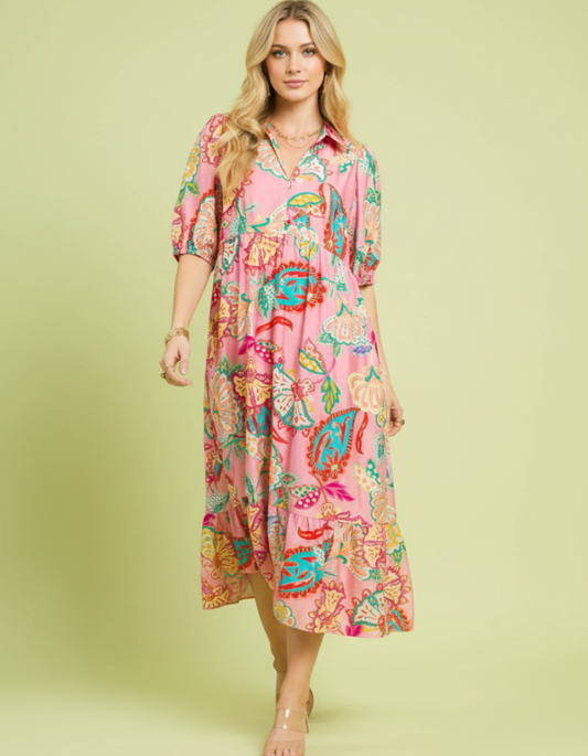 Woman wearing a colorful floral dress on a light green background